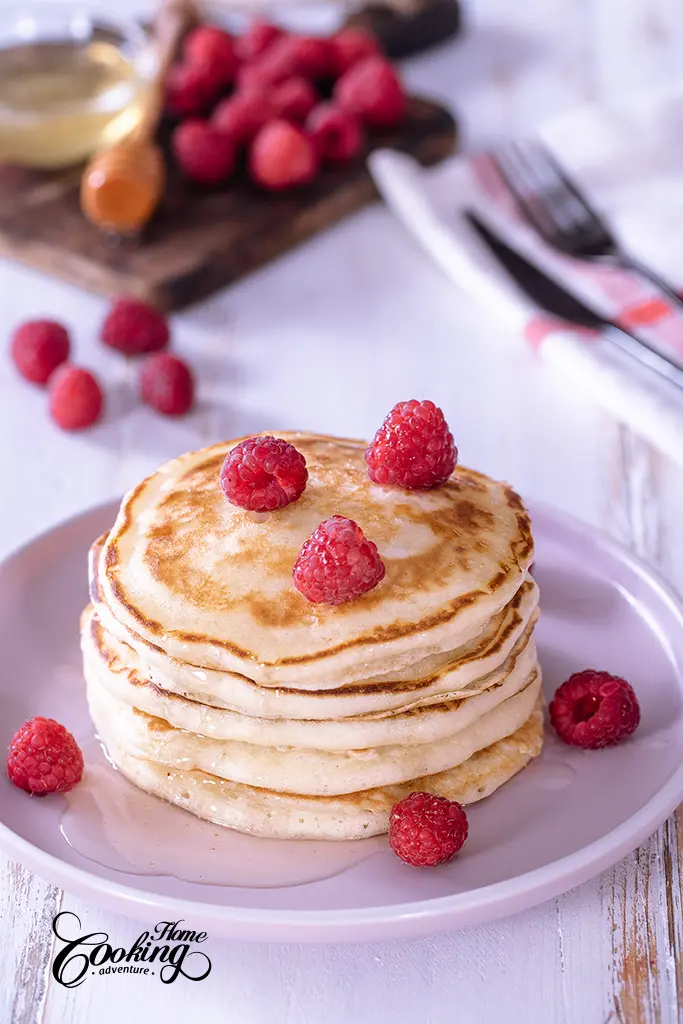 Fluffy Buttermilk Pancakes with fresh berries and honey