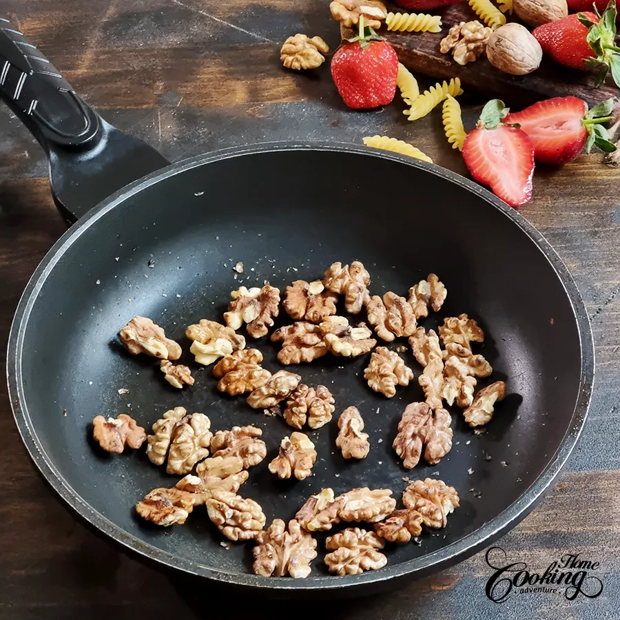 Toast walnuts in a skillet