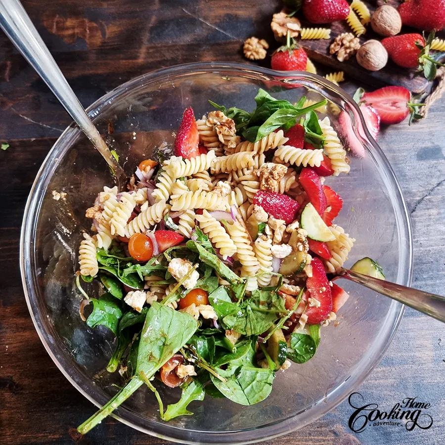 tossing the salad with the dressing