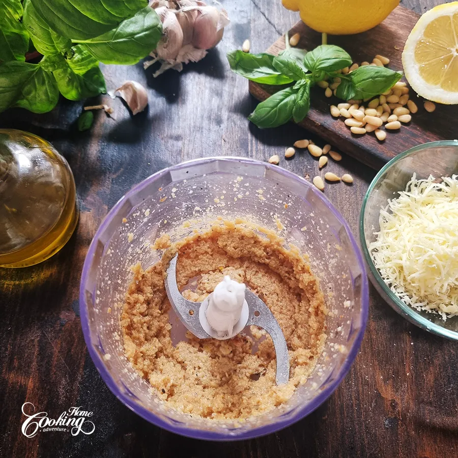 Processing pine nuts with garlic, lemon juice, salt and pepper