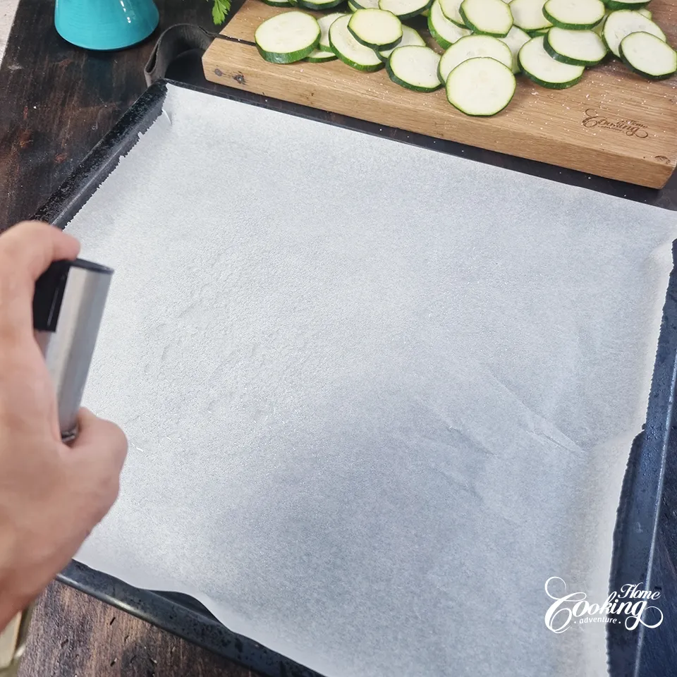 spraying the baking sheet with oil