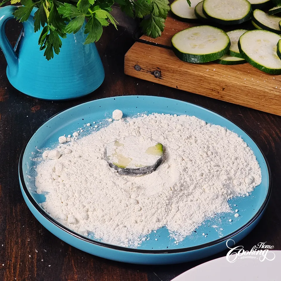 Dredge zucchini rounds in flour