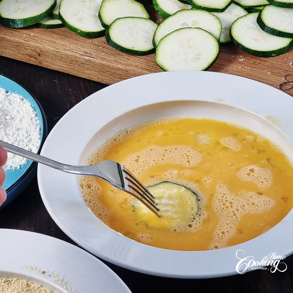 dip zucchini rounds in beaten eggs